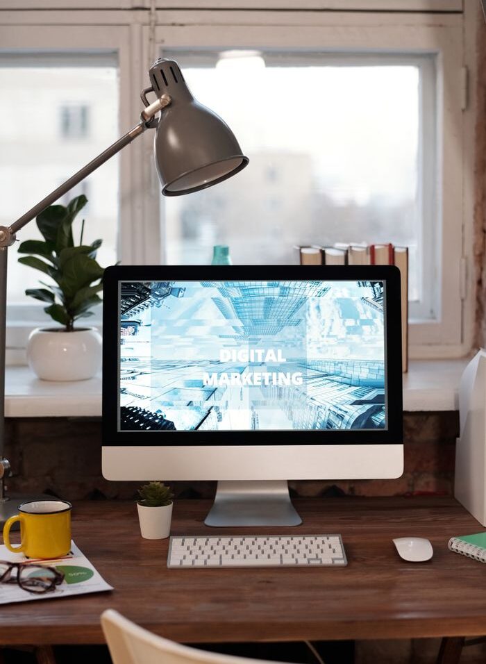 Contemporary home office desk with digital marketing screen, perfect for remote work inspiration.