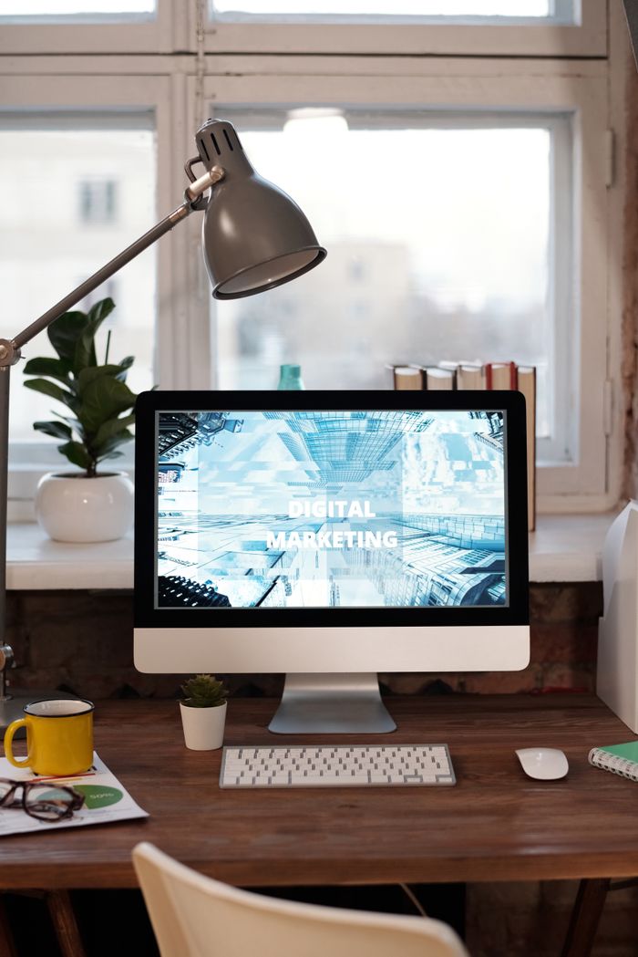 Perché oggi ogni azienda ha bisogno di un sito web? Contemporary home office desk with digital marketing screen, perfect for remote work inspiration.